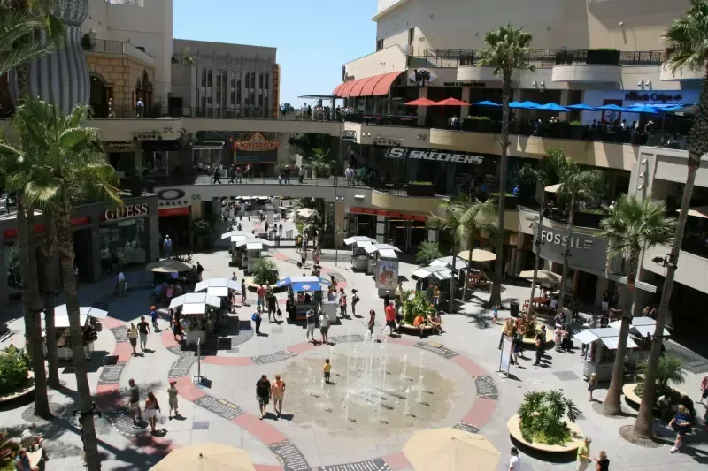 An aerial view of a shopping mall with a fountain in the middle