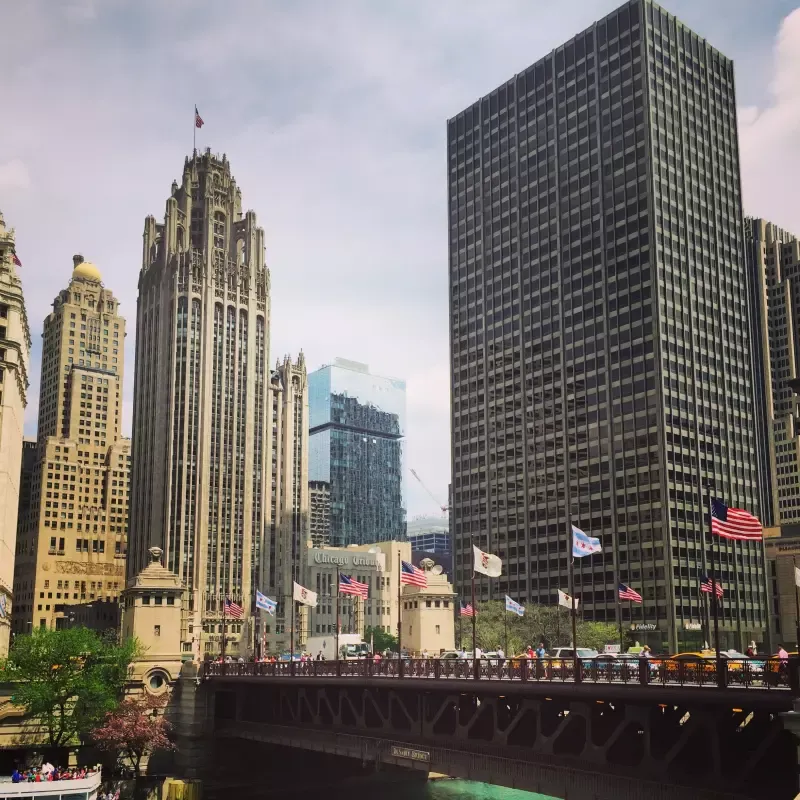 A bridge in the middle of a city surrounded by tall buildings