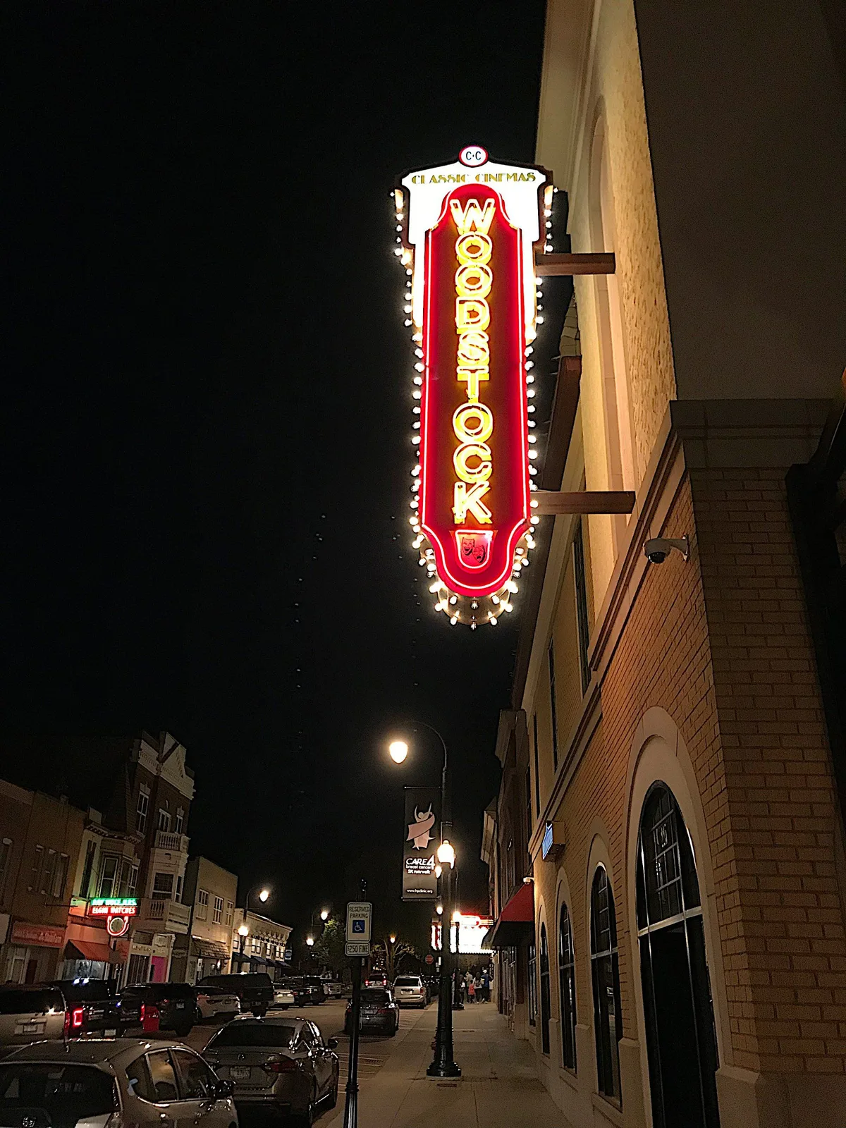 A neon sign that says ' Woodstock' on it