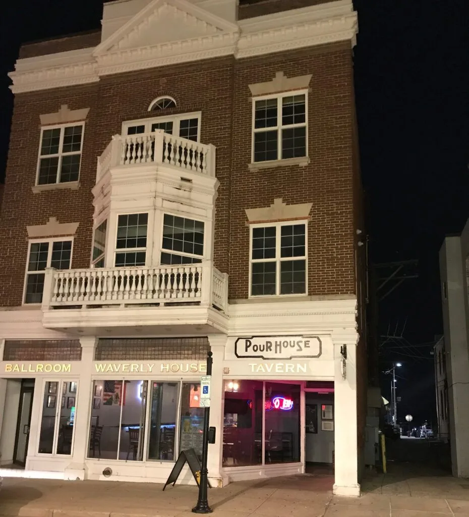 A brick building with a sign that says pour house tavern