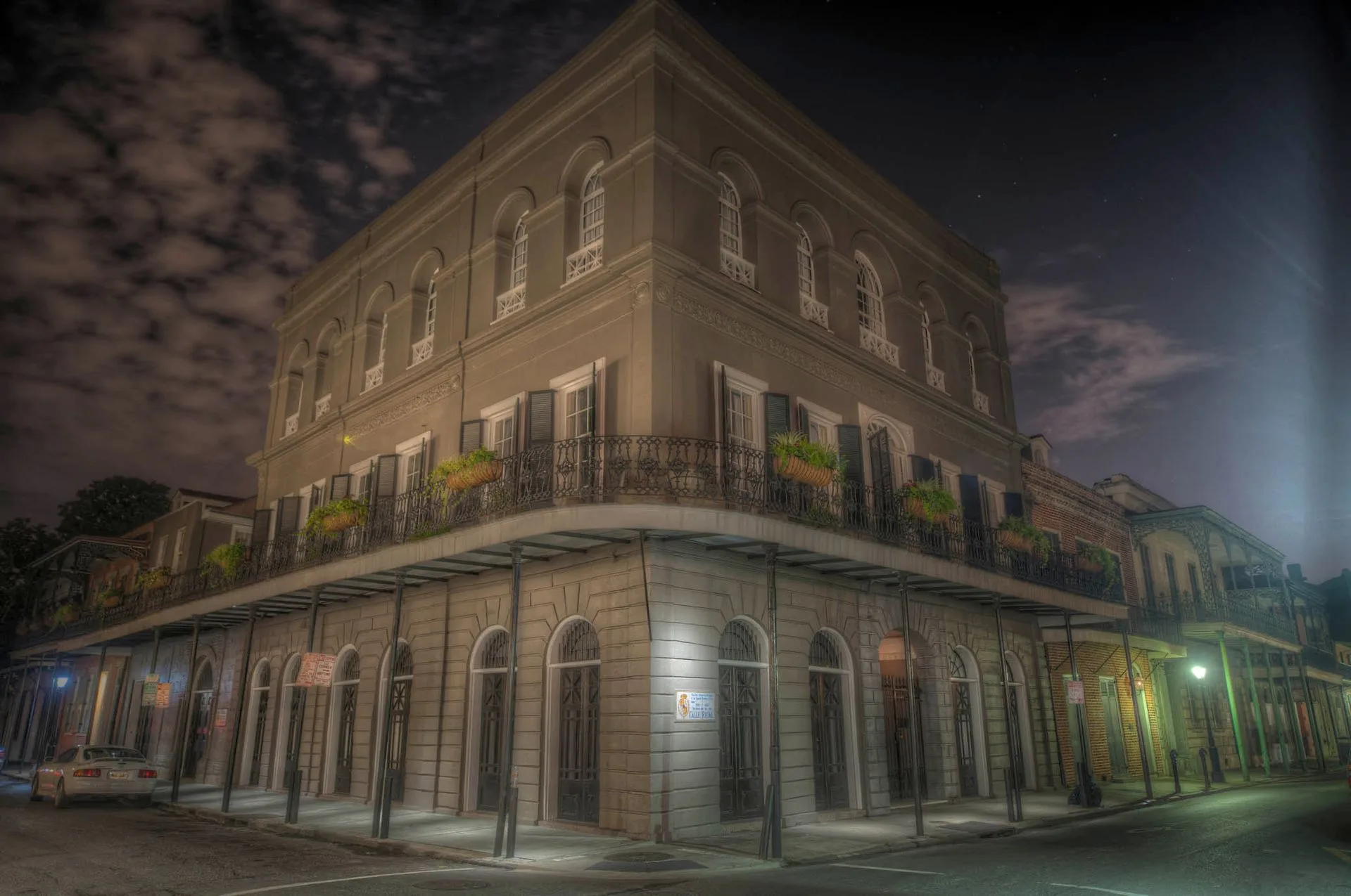 A large building with a balcony on the corner of it