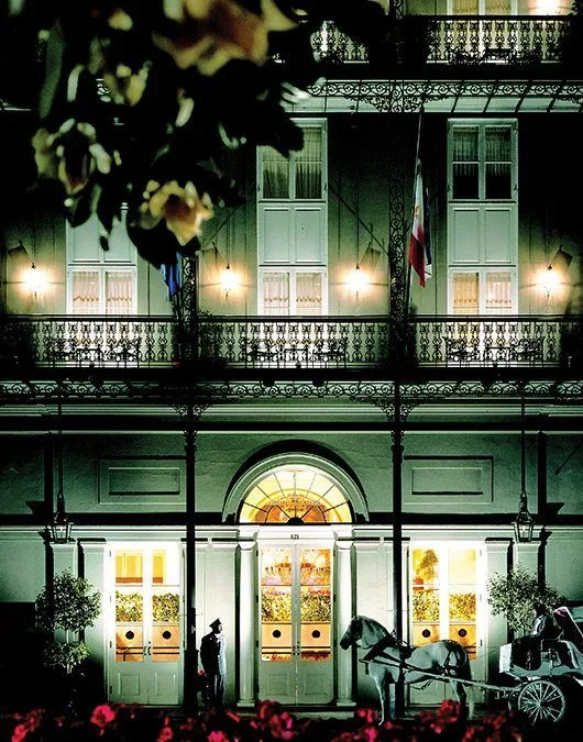A large building with a horse drawn carriage in front of it