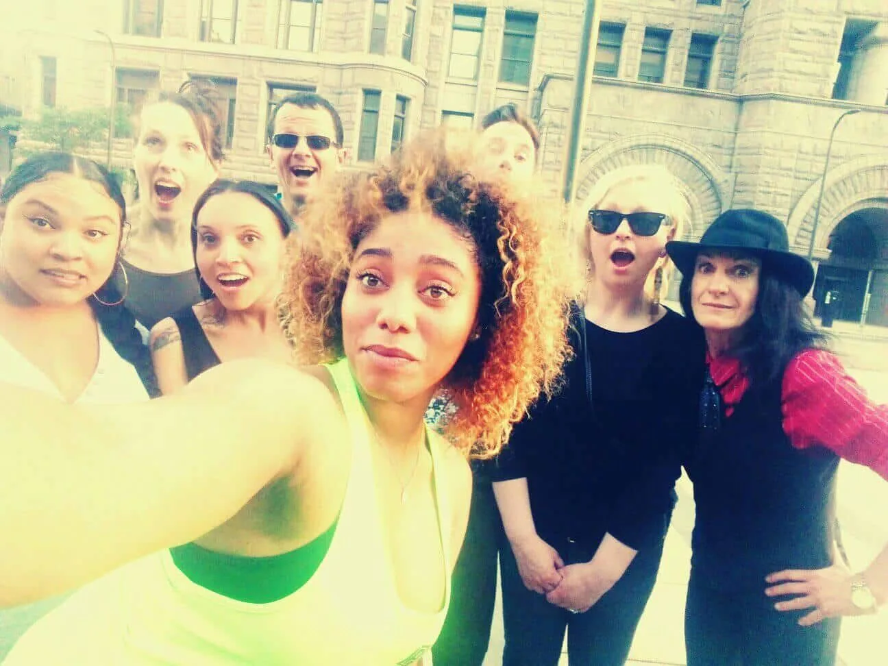 A group of people are posing for a picture in front of a building