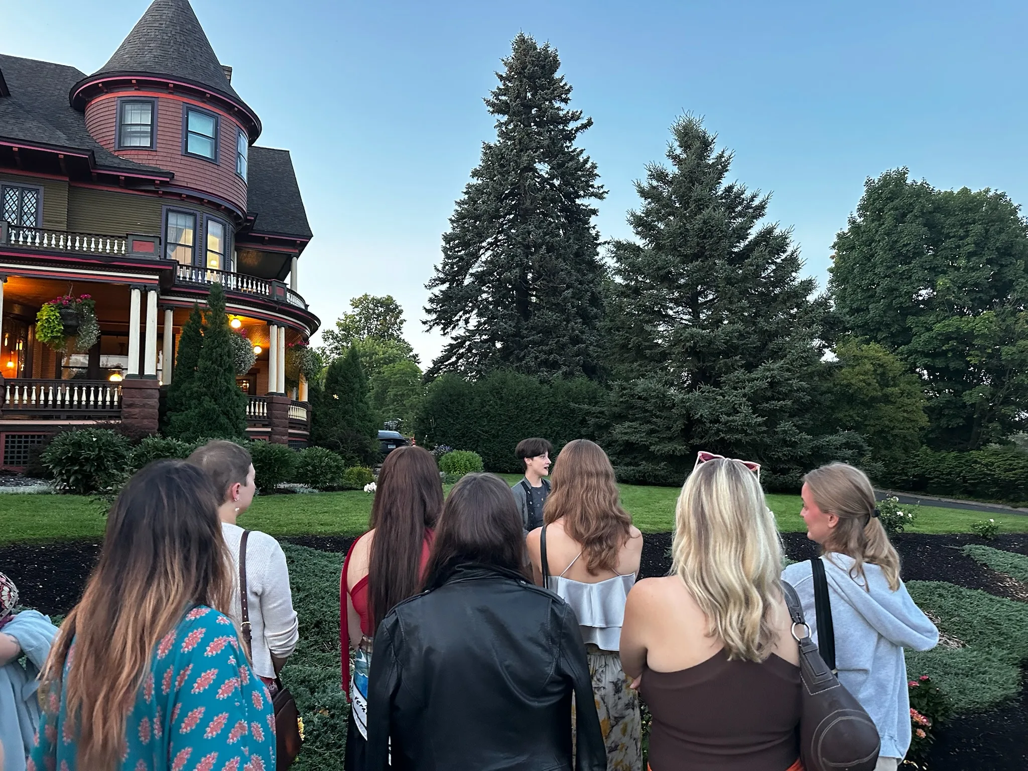 Private group ghost tour gathered with a guide at a haunted location