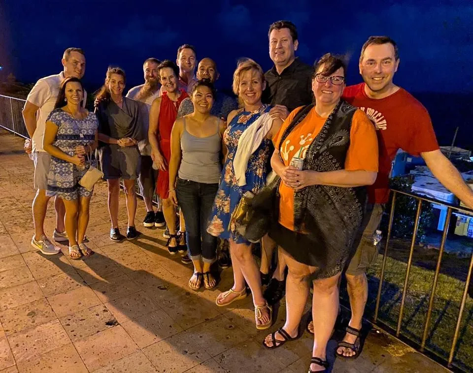 A group of San Juan ghost tour guests posing in Old San Juan at night